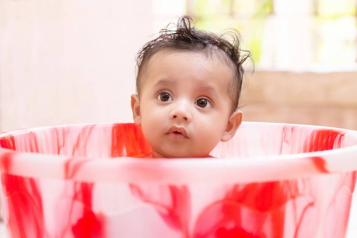 Mother using organic baby bath products during evening routine